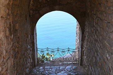 View of the sea through an old stone window on the Palamidi fortress Nafplio