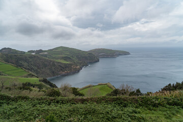 coastal view of the green hilly cliffs in the azores portugal