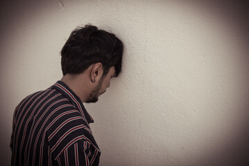 Smart thai man very sad from unrequited love,rethink,think over,vintage style,dark tone,Sad unhappy handsome man broken heart,Unpleasant pain,Thailand people