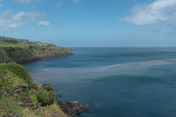 Landscape in Sao Miguel island with volcanic rocks touching the sea. 