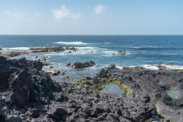 Fototapeta na wymiar black rocks in the sea at the coast of the azores portugal 