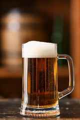 Mug of beer on table in bar. Oktoberfest celebration