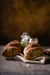 Fresh homemade bread whole wheat baguette white milk and honey on rustic wooden board and abstract table. Sourdough bread

