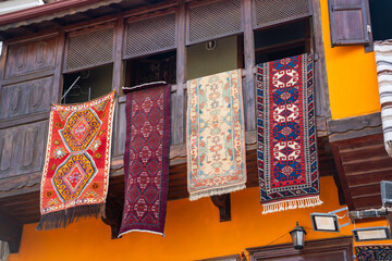 Old typical house in oriental style with carpets on the balcony in Fethiye, Turkey
