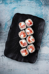Sushi maki rolls with shrimp, cream cheese and red sweet pepper.