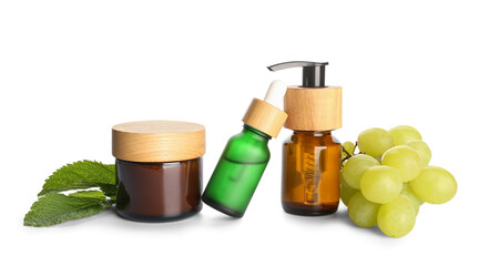 Set of cosmetic products, mint and grapes on white background