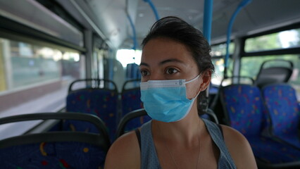 Fototapeta na wymiar Commuter woman wearing face mask inside public transportation