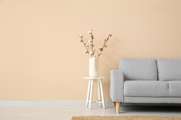Interior of living room with sofa  and cotton branches