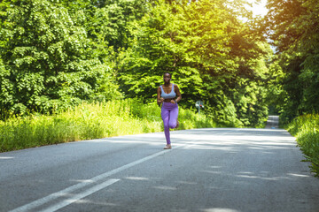 One african american female athlete looking focused while out for run to increase her cardio and endurance. A young black woman running outside to increase her speed and pace. Fitness is a lifestyle.