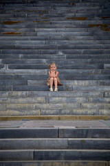 Portrait of a girl sitting on concrete steps