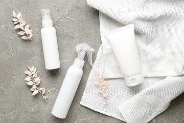 Composition with cosmetic products, dried plants and clean towels on grunge background