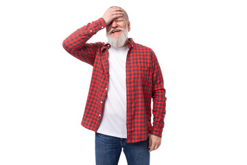 handsome frustrated 60s elderly man with a gray beard in a shirt