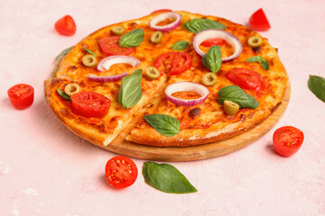 Board with tasty pizza, olives and basil on pink background