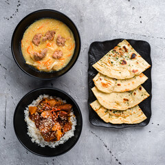 Naan flatbread with cilantro, soup with noodles and pork with basmati rice and pineapple.