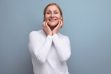 blond pensive middle-aged woman in a white sweater