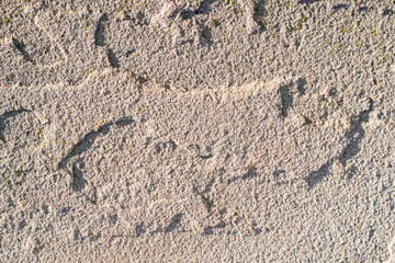 Sandstone stone texture with grain and irregularities in bright sunlight