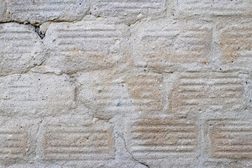 Texture of a concrete wall with traces of dismantled facing tiles
