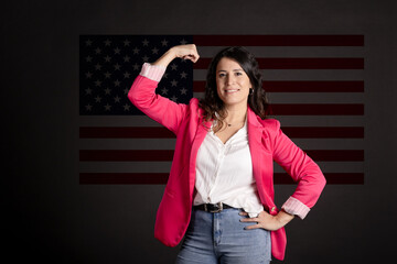 Worker woman raising her arm. United States flag behind. Labor day concept.