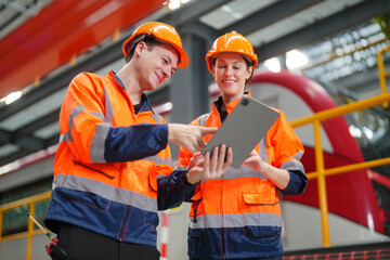 Engineers inspecting locomotive in railway engineering facility