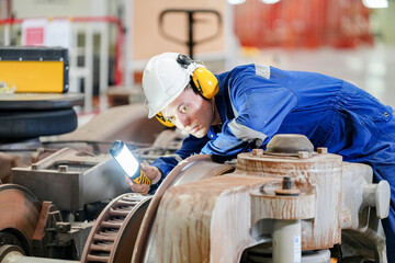 Engineers inspecting locomotive in railway engineering facility © FotoArtist