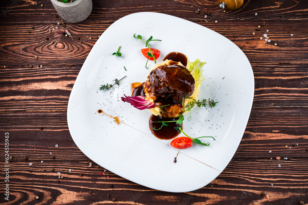 Poster Beef steak with mashed potatoes, cherry tomatoes, greens and sauce in a plate, fresh meal.