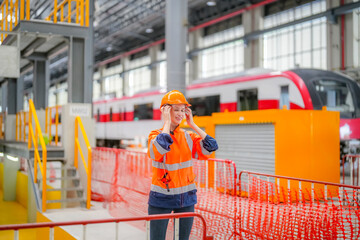 Engineers inspecting locomotive in railway engineering facility