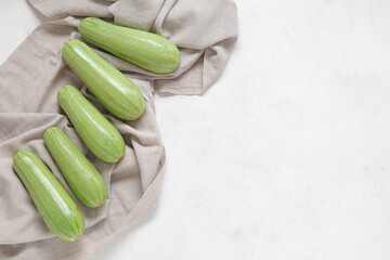 Fresh green zucchini on light background