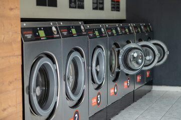 Industrial laundry machines in a public laundromat.