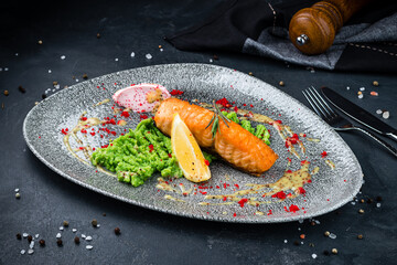 Salmon fillet with broccoli puree, lemon and red caviar, fresh lunch.