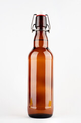 Brown beer bottle with bugle plug isolated on white background.