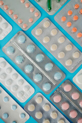 Pharmaceutical drugs, antibiotics, pills. Colorful pills on a blue background, capsule pills