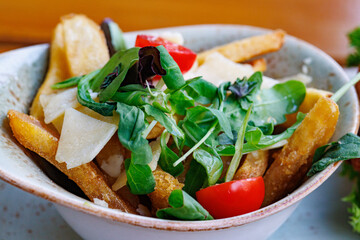 French fries with salad and cheese