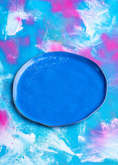 Blue empty hand made plate on color background