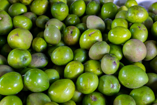 Bunch of Green Jocotes (Spondias purpurea) Known as Ciruela or Purple Mombin, a Fruit Native to Central America on a Stall in Colorful Market "Mercado Mayor"