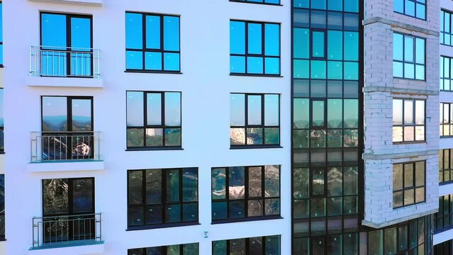 Many windows on new apartment building facade under construction
