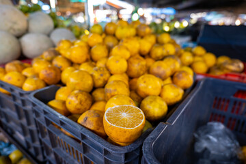 Bunch of Ripe Oranges in Blue Box in Colorful Market 