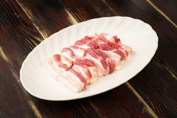 Fresh pork slices on a simple background