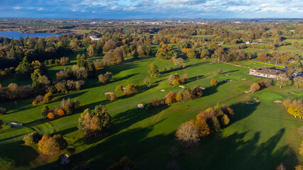 Aerial View of Mullingar golf course in Ireland on a sunny Autumn day with multi-coloured trees.