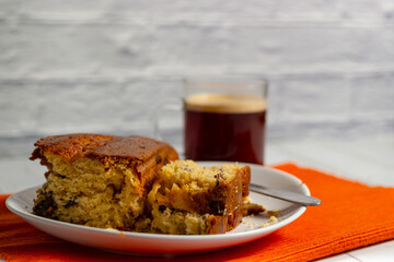 Pieces of Pound Cake in a dish with a glass mug of coffee