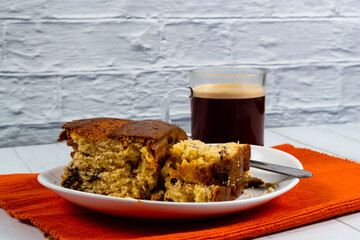 Pieces of Pound Cake in a dish with a glass mug of coffee