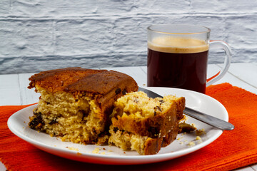Pieces of Pound Cake in a dish with a glass mug of coffee