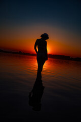 Fototapeta premium Silhouette of a sensual woman at sunset