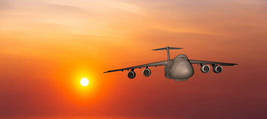 Fototapeta premium US Air Force military transport airplane on a sunset sky background
