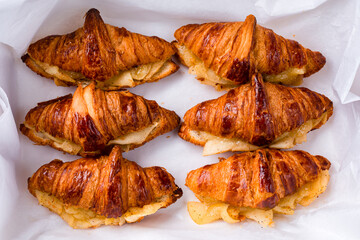 French croissants with with baked pear and cinnamon in a box.