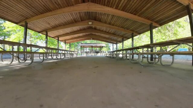 aerial FPV footage of a gorgeous summer landscape at Proctor Landing park with a lake, lush green trees, grass and plants with blue sky and clouds at Lake Acworth in Acworth Georgia USA