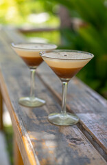 Two glasses of espresso martini at a beach bar in the Maldives