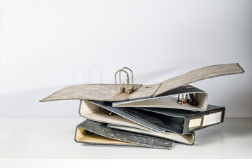 Old empty file folders or ring binders on a white office desk in an archive, concept for...