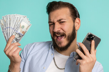 Lebanese man looking smartphone display sincerely rejoicing win, receiving money dollar cash...