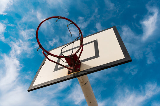 Backboard with basketball basket with sky in the background