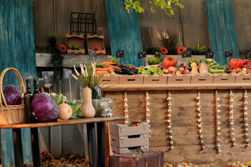 Autumn harvest on farmers market counter with wide variety of colorful organic fruits and vegetables, empty local market. Seasonal products farm produce stand with healthy natural food.